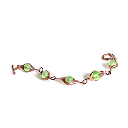 Artisan bracelet antiqued copper cultured SEA GLASS wire-wrapped . 10mm round beads & toggle clasp - green